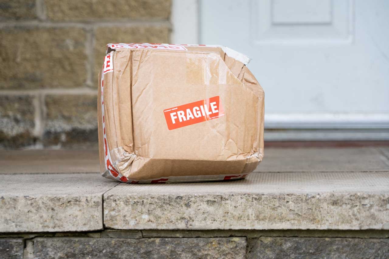 Damaged fragile parcel delivered to doorstep