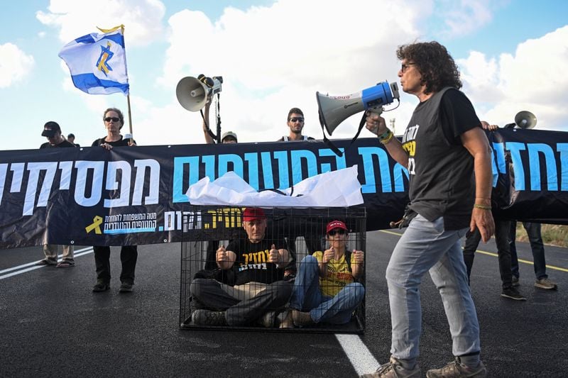 Image for Families leave Gaza City after night of bombardment, Israelis protest