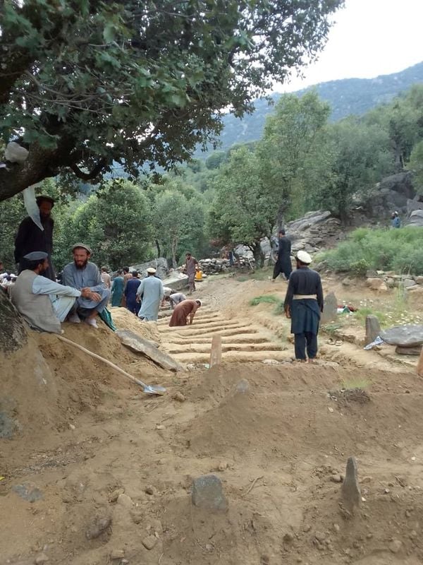 Image for Afghan quake survivors dig graves with pickaxes as entire households wiped out