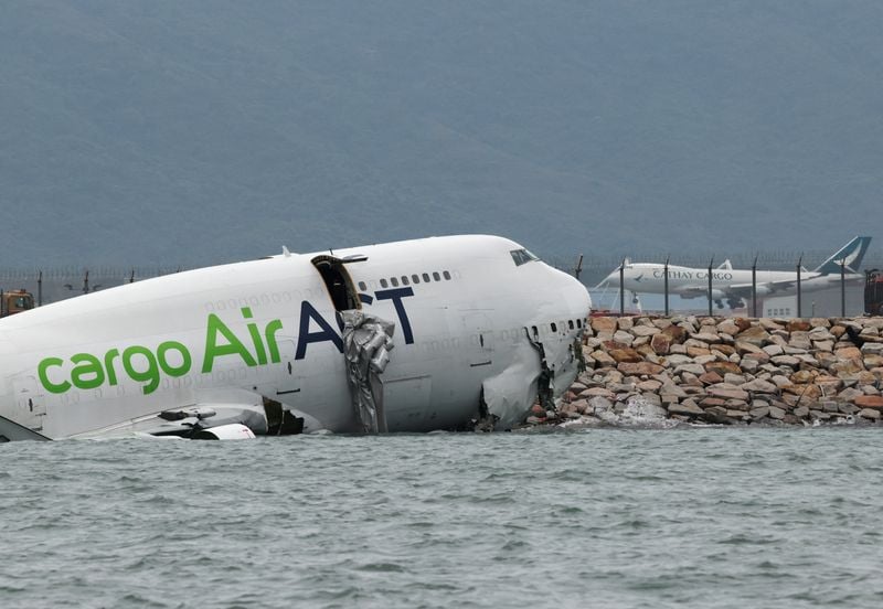 Image for Cargo plane slides off runway in Hong Kong, killing two airport staff