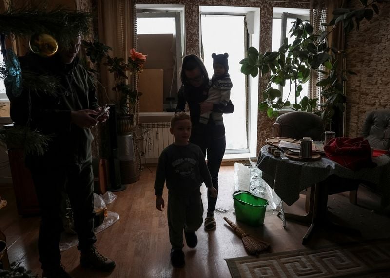 Image for Kyiv residents grapple with cold after Russian strike rips open apartments