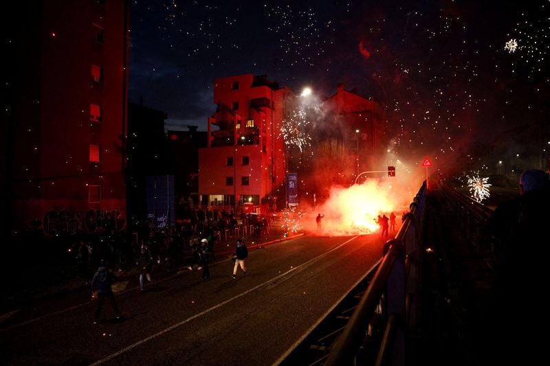 Image for Hooded protesters throw flares at police at end of demonstration in Olympic host city Milan
