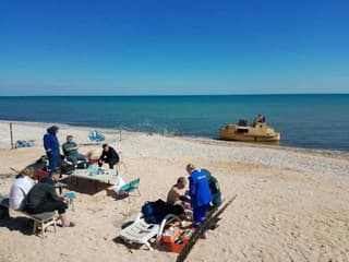 Image for Russian grain ship believed sunk in Ukrainian drone attack is found and towed to shore, TASS says
