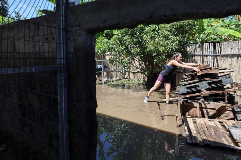 Image for Waters recede in Bali after floods kill 18 people, with two still missing