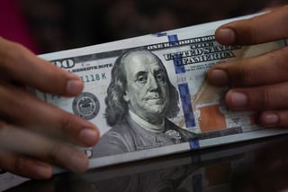 Dollar poised for third weekly gain as buoyant data seen keeping Fed cuts at bay