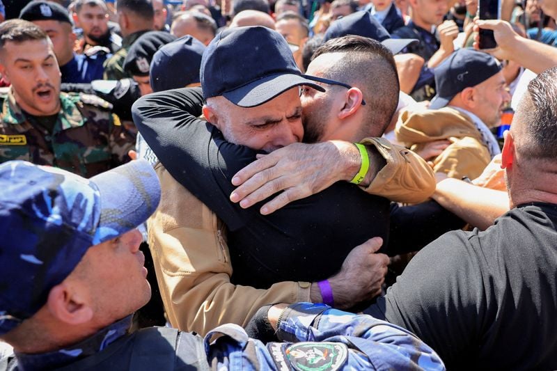 Image for Palestinians cheer as freed prisoners begin to arrive home under ceasefire deal