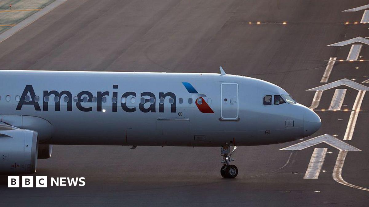 BBC News image for Laptop catches fire on US flight, with passenger treated at airport