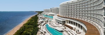 Aerial view of hotel and pool with beach