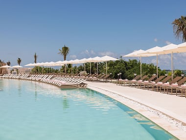 Pool area with sun loungers and umbrellas