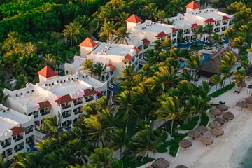 Aerial view of resort with beach, tropical gardens and ocean