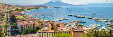 The Bay of Naples with Mount Vesuvius in the background and buildings in the foreground