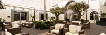Garden area with furniture and trees under a cover