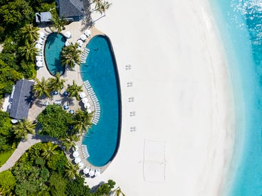Birdseye view of a beach with a pool on it