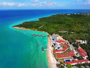 Aerial view of beach and sea next to a resort
