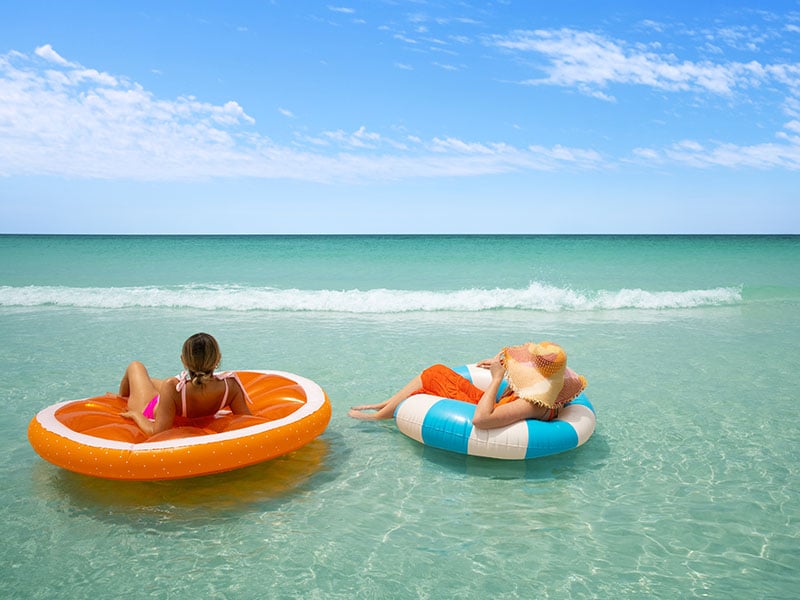 two ladies in floats on panama city beach