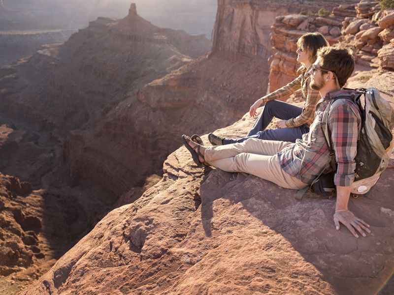A couple rest during an Arches National Park hike