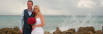 Bride and groom on the beach at Crystal Cove by Elegant Hotels