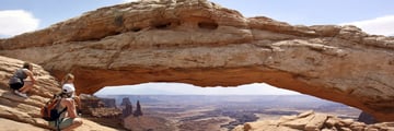 Family hiking in Mesa Arch, Utah