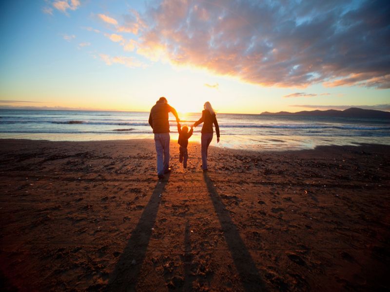 family on the beach in NZ