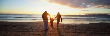 Family having fun on the beach in New Zealand