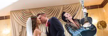 Elvis serenading a married couple in Graceland Wedding Chapel