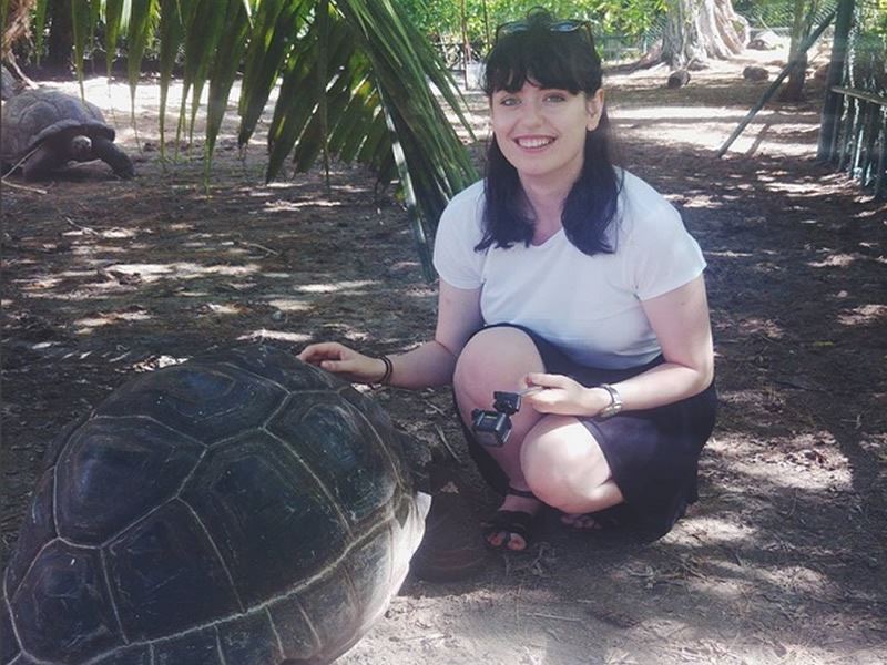 hazel with a giant tortoise called toby in the seychelles