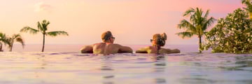 Newlywed couple relaxing together in the pool
