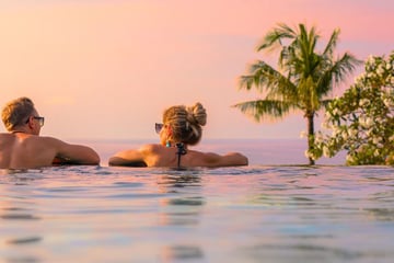 Newlywed couple relaxing together in the pool