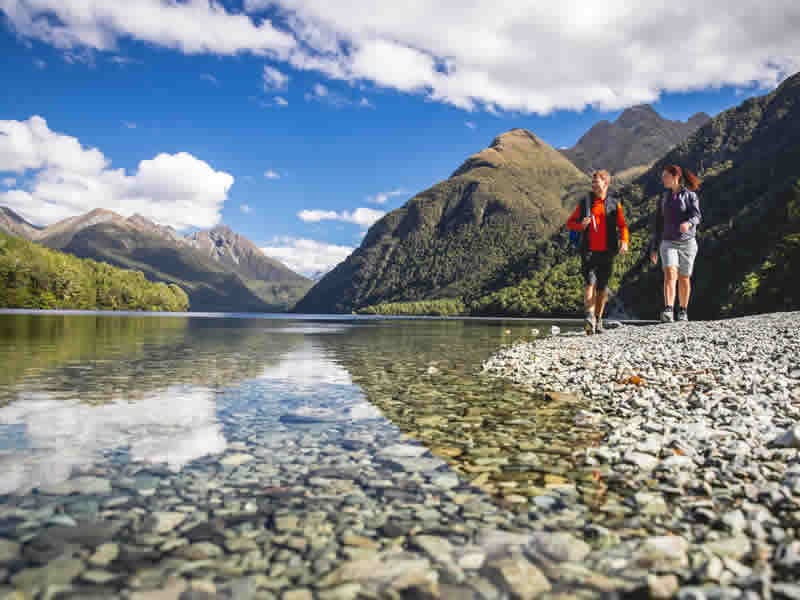 Couple hiking Lake Gunn, Fiordland, South Island, New Zealand