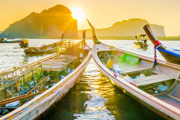 Long boats at sunset in Krabi