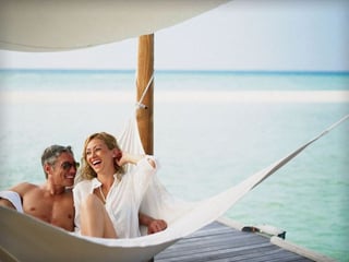 The happy couple relaxing on the beach