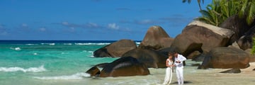 Newlyweds celebrating on the beachfront at Hilton Seychelles Labriz