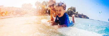 Mother and son enjoying the waves
