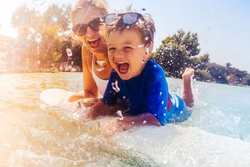 Mother and son enjoying the waves