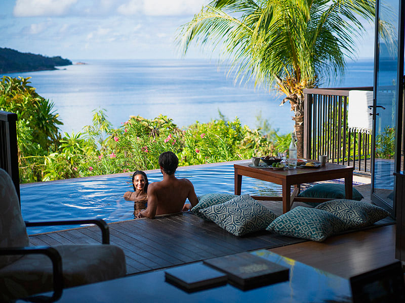 couple in pool at Raffles Seychelles