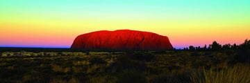 Uluru at sunrise with rainbow skies