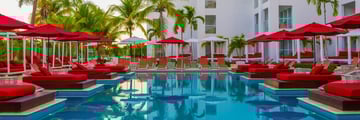 S Hotel Jamaica main pool with red daybeds and umbrellas