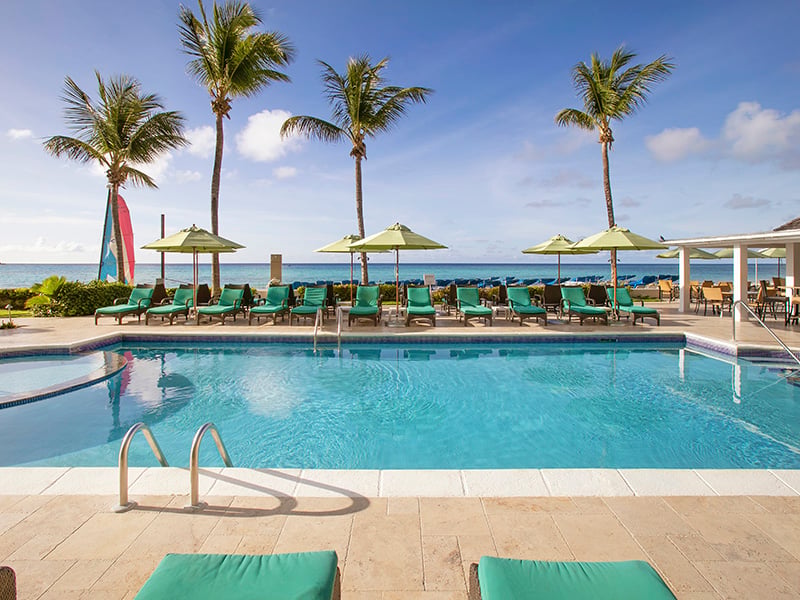the family pool at sea breeze beach house and palm trees and beach views