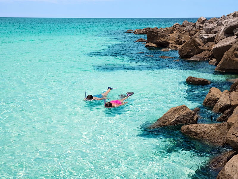two kids snorkelling in the sea