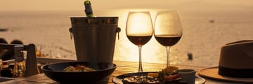 Enjoying an alfresco dinner by the beach at sunset