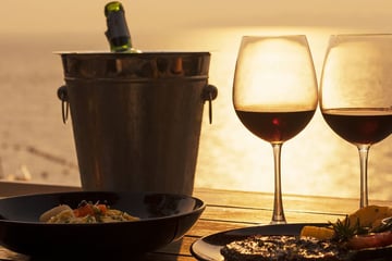 Enjoying an alfresco dinner by the beach at sunset