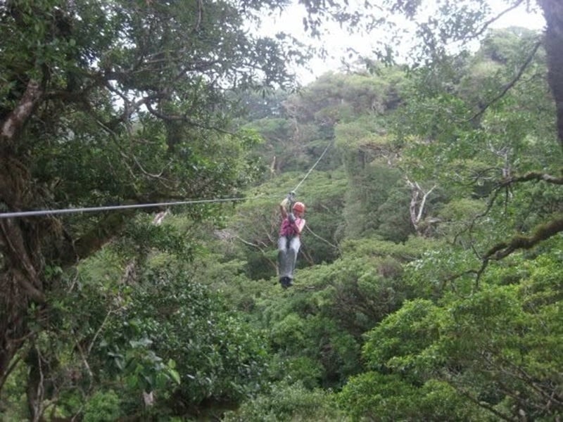woman ziplining in monteverde cloud forest