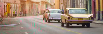 Vintage cars driving along Havana streets