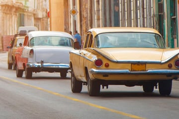 Vintage cars driving along Havana streets