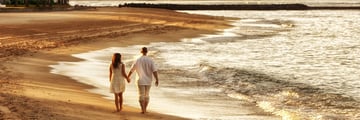 Couple walking along Waikiki Beach