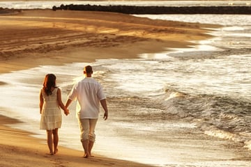 Couple walking along Waikiki Beach