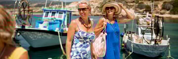 Women walking along the harbour, Cyprus