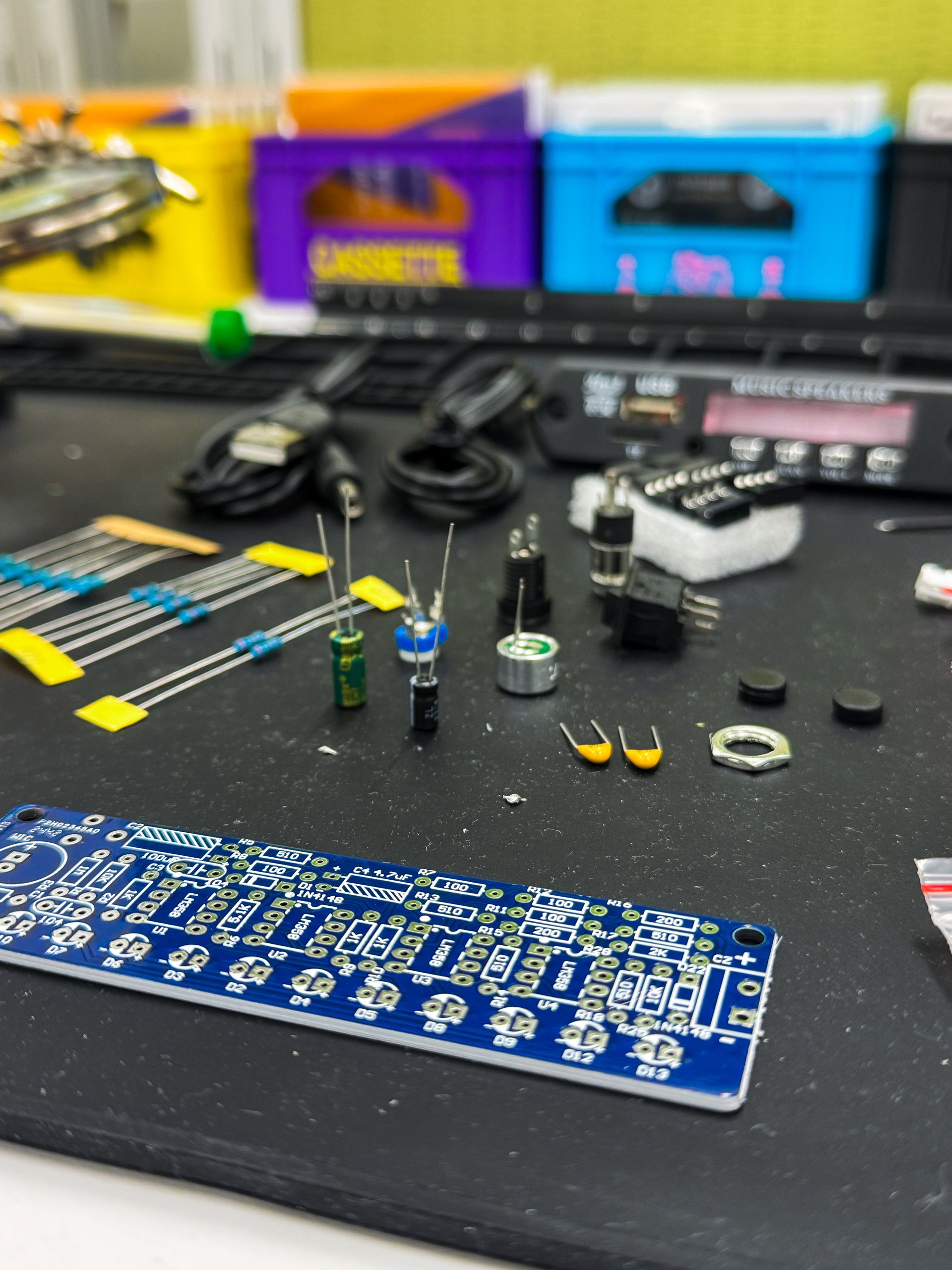 A close-up of a hand-built circuit board with soldered joints and wiring.