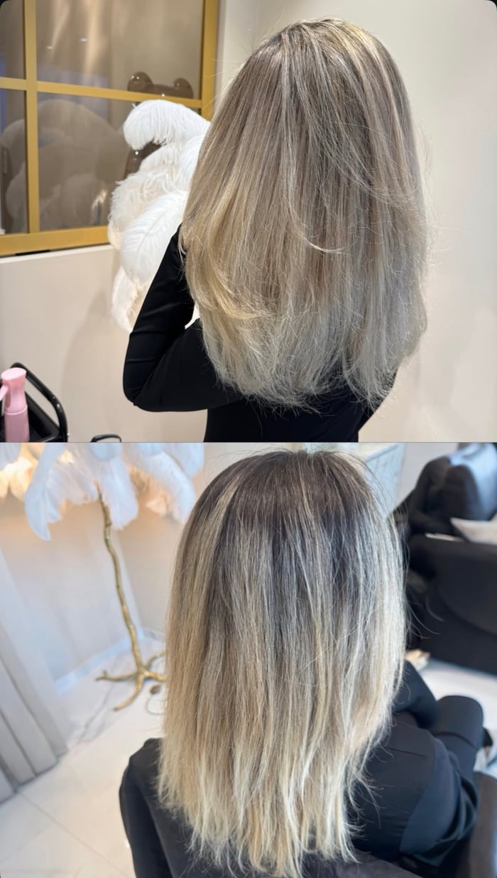 Kühles Aschblond-Balayage an mittellangem Haar, gestyltes Ergebnis in Rückansicht
