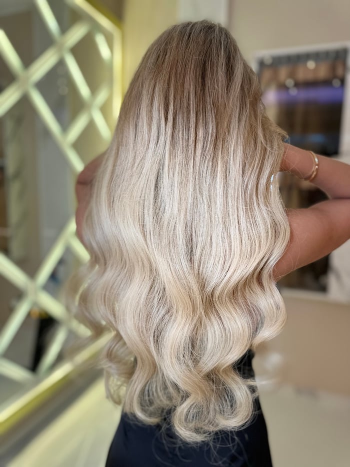 Lange voluminöse blonde Wellen mit Balayage in Rückansicht
